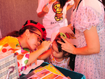 An artist painted on a girl's face, body painting increased the delight and happiness of the event.